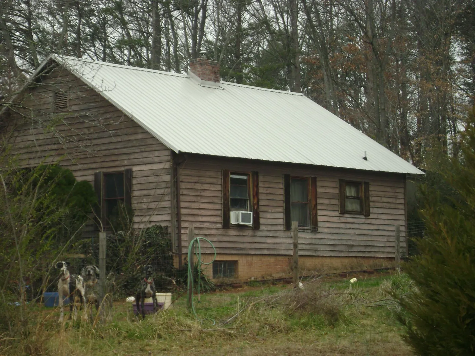 White metal roof on an old wood sided farmhouse, from a Metal Roof Installation job in Wildersville